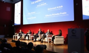 Five people speaking on a stage