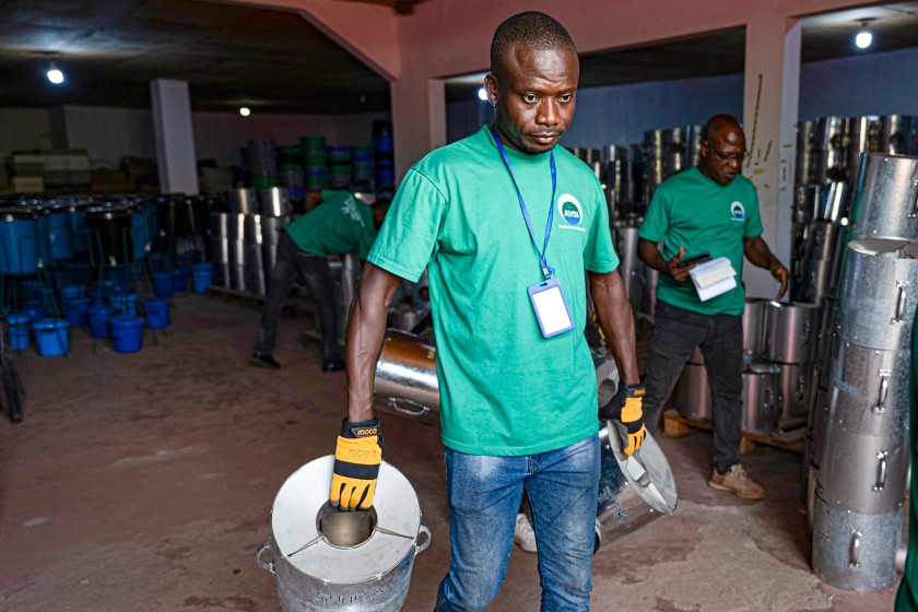 African man carries the hob out of the production laboratory