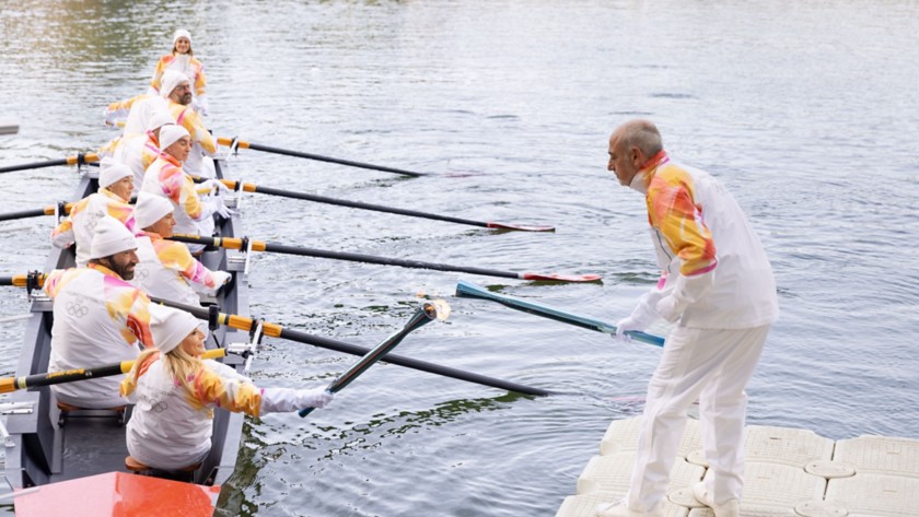Tedofori sulla canoa trasportano la Torcia Olimpica