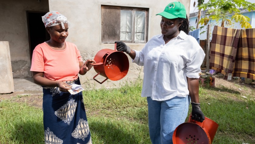 Two women using improved stoves