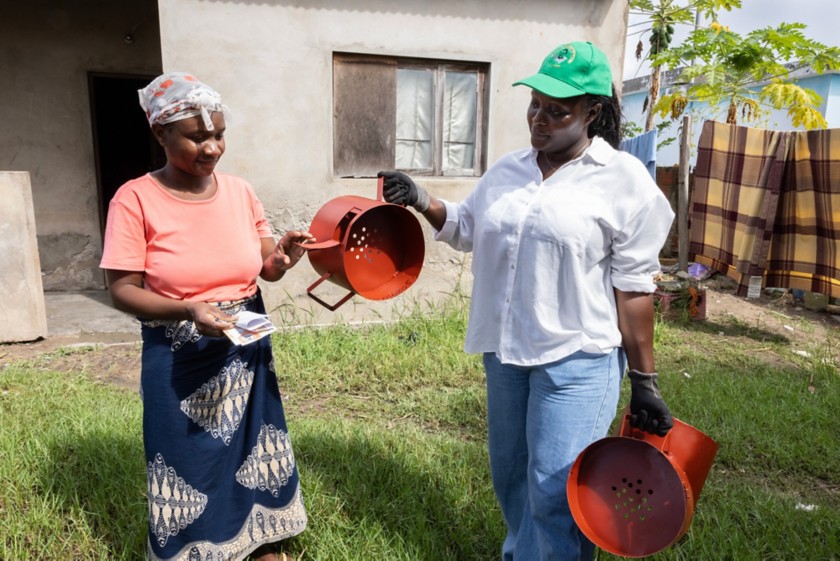 Two women using improved stoves