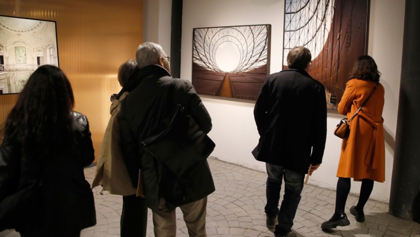 Five people look at an artwork at Arte al Gazometro