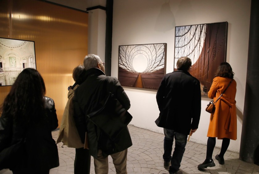 Five people look at an artwork at Arte al Gazometro