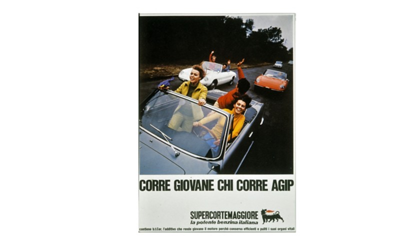 Three cars—blue, orange, and white—on a road, each carrying young passengers who are smiling and waving to one another