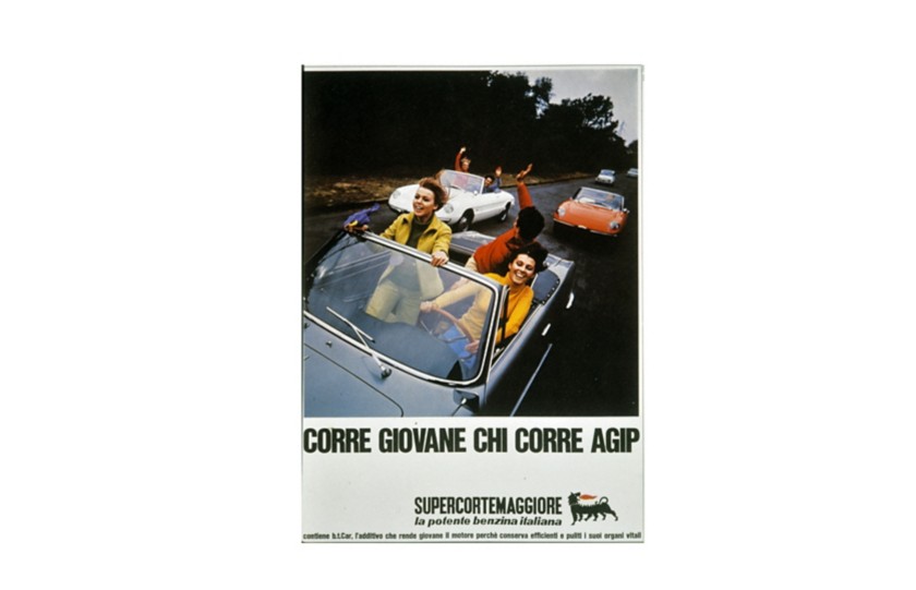 Three cars—blue, orange, and white—on a road, each carrying young passengers who are smiling and waving to one another