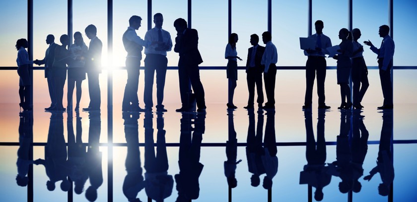 People talking to each other, a transparent glass window in the background