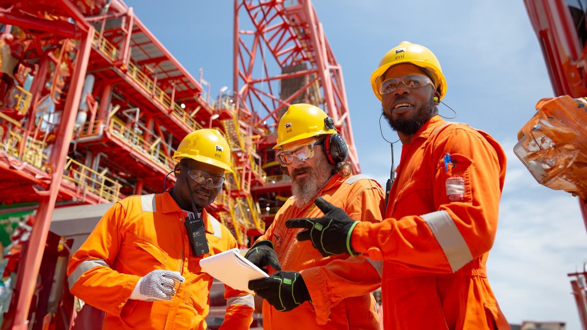 Workers aboard ship talk among themselves about work to be done