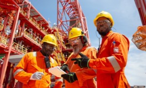 Workers aboard ship talk among themselves about work to be done