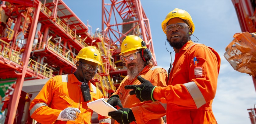 Workers aboard ship talk among themselves about work to be done