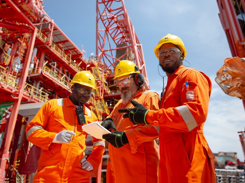 Workers aboard ship talk among themselves about work to be done