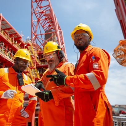 Workers aboard ship talk among themselves about work to be done