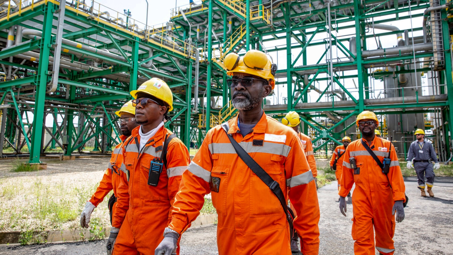 Congolese workers walk inside the plant