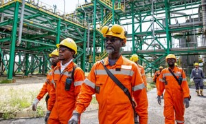 Congolese workers walk inside the plant