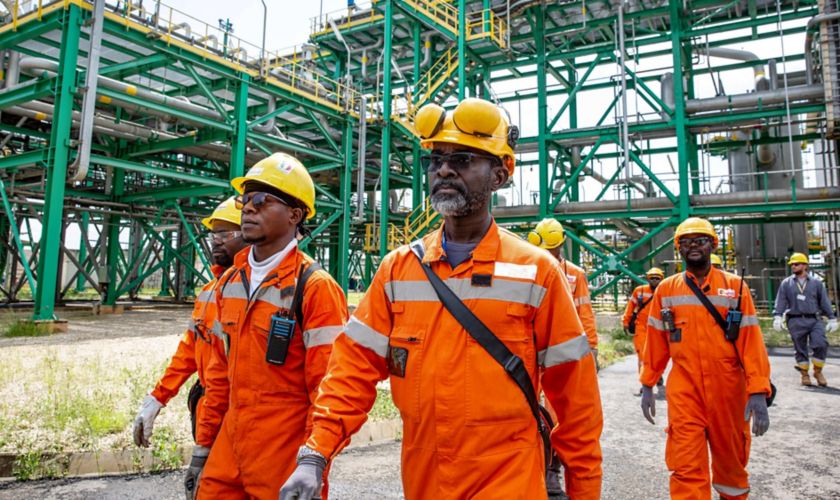 Congolese workers walk inside the plant
