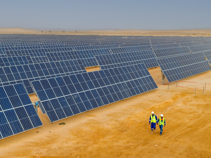 Workers walking in solar panel plant in Tunisian desert
