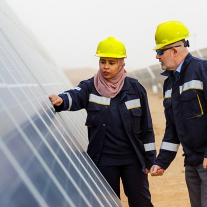 Tunisian woman and man workers check solar panel