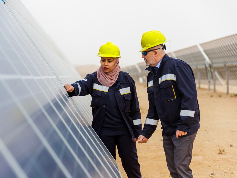 Tunisian woman and man workers check solar panel