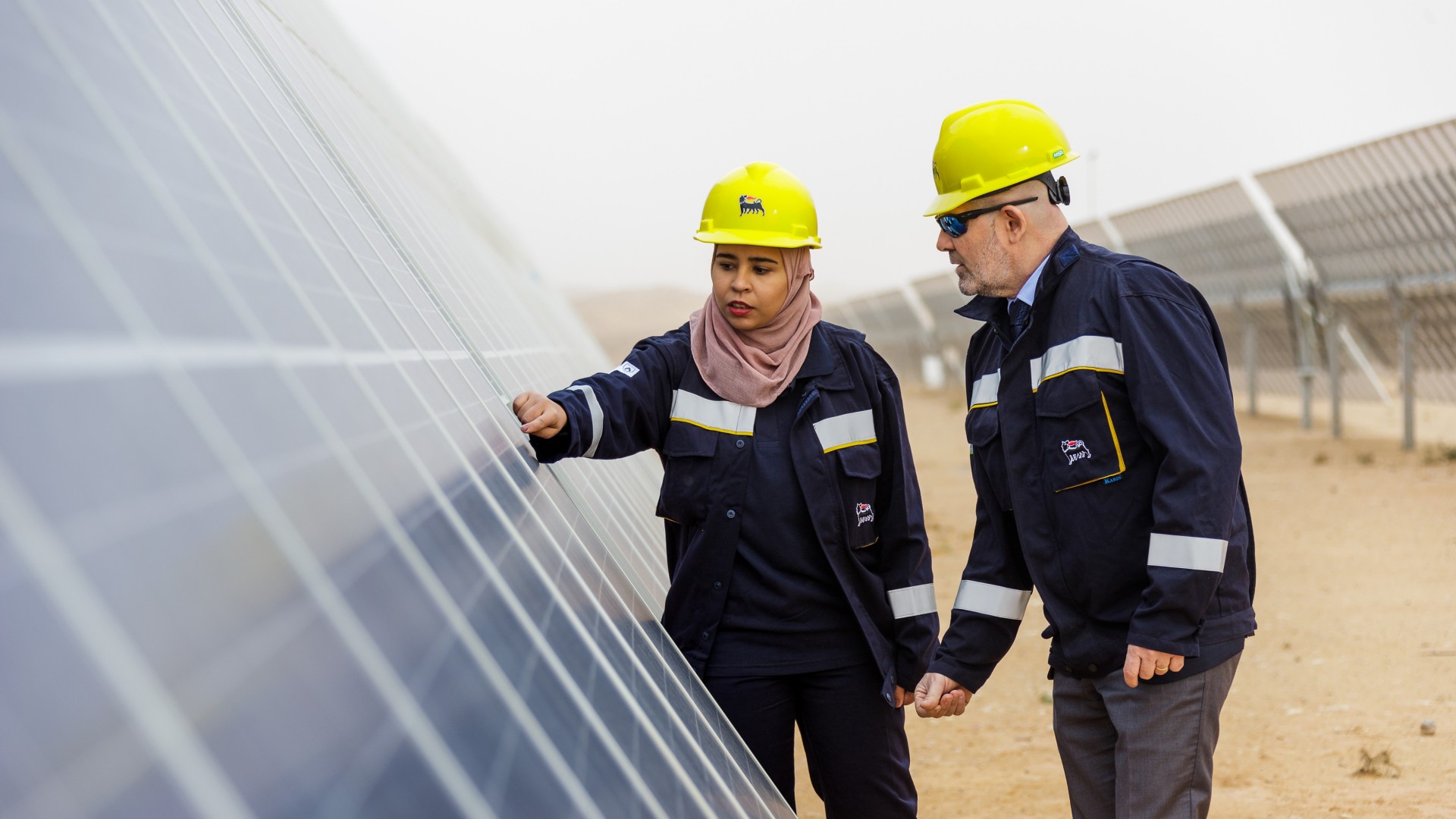 Tunisian woman and man workers check solar panel