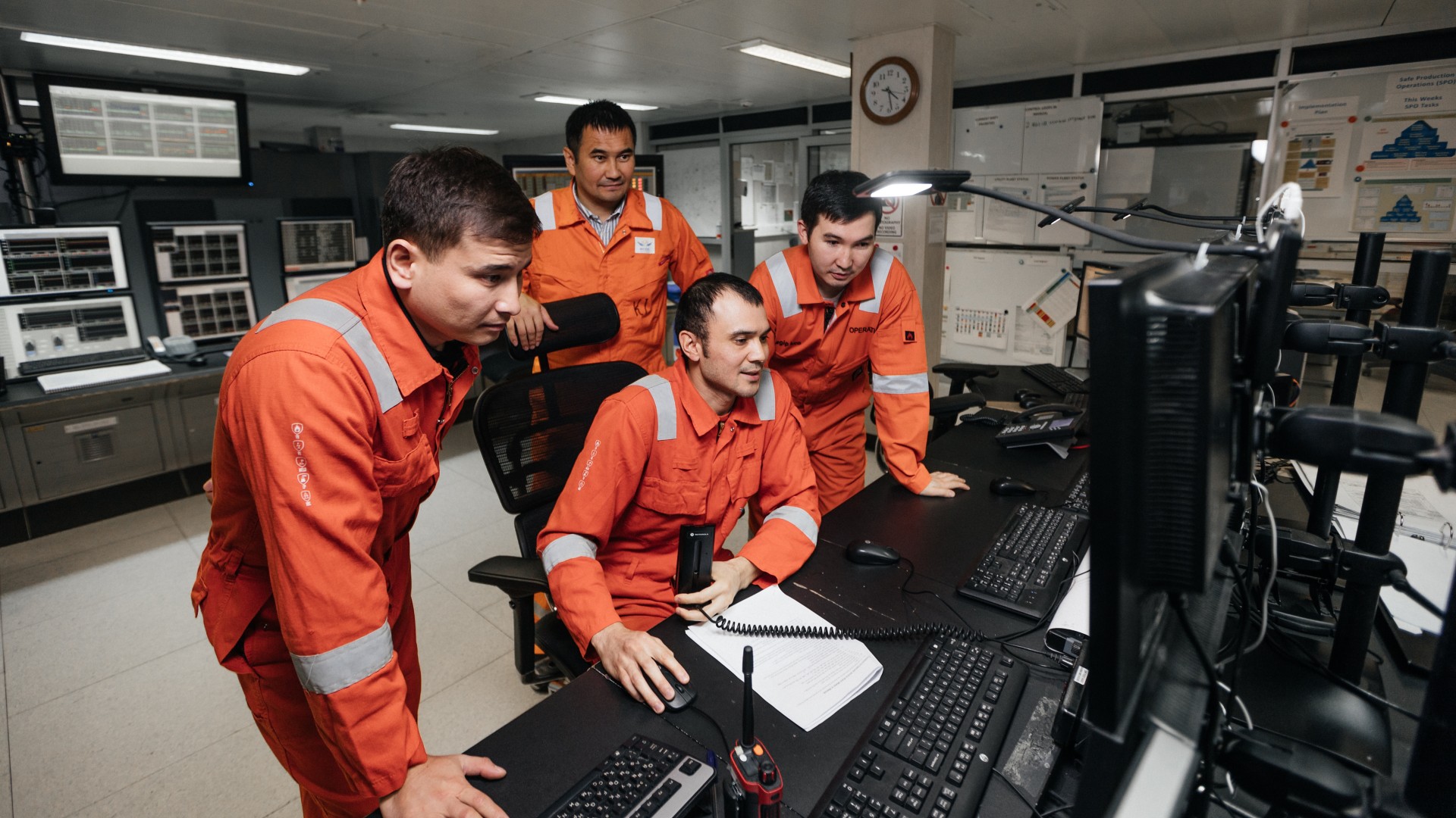 Group of workers observe a colleague's computer together