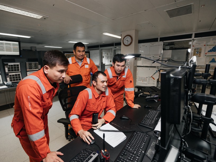 Group of workers observe a colleague's computer together