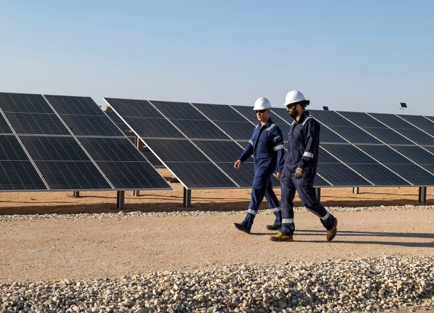 Two workers walk through the photovoltaic plant