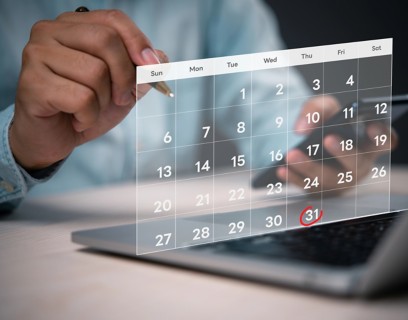 A person’s hand pointing at a digital calendar, with the 31st circled in red.