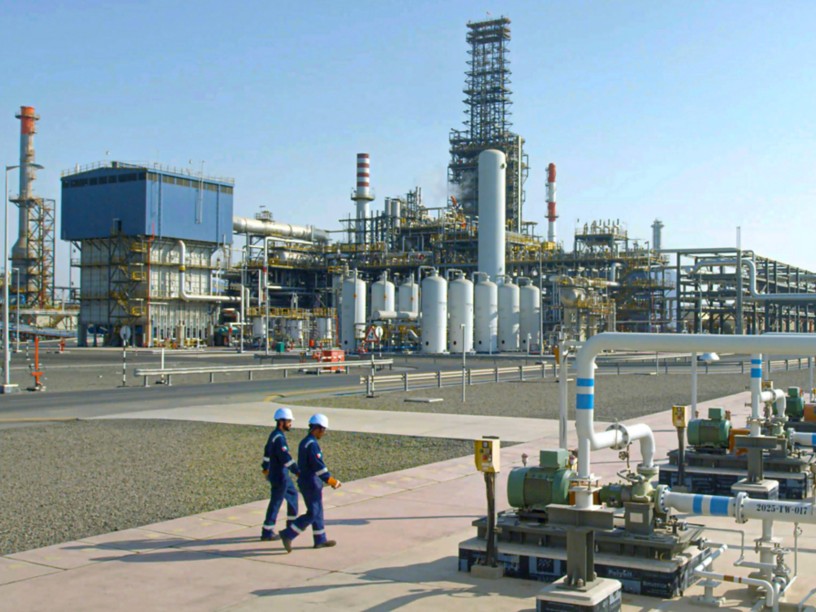 Refinery outdoors with workers inside