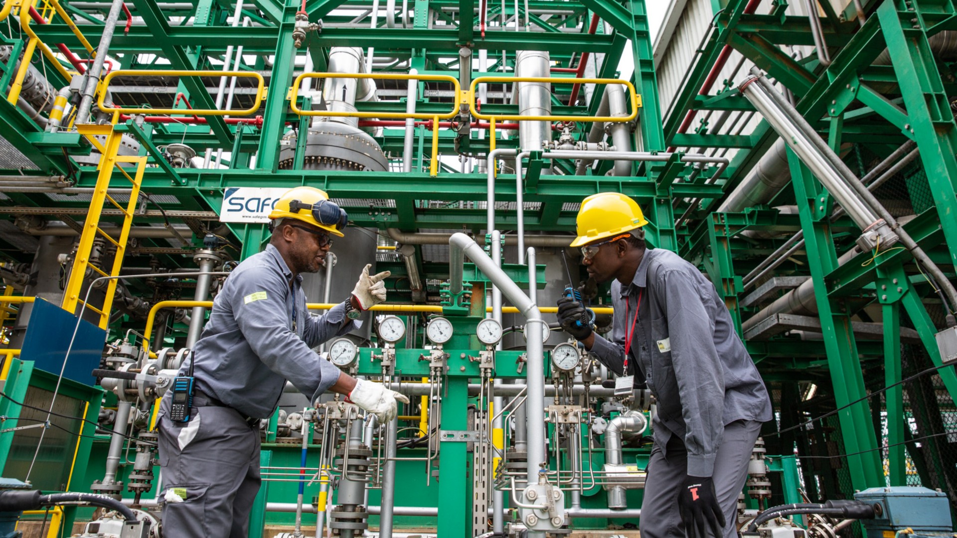 Two workers inside the gas plant.
