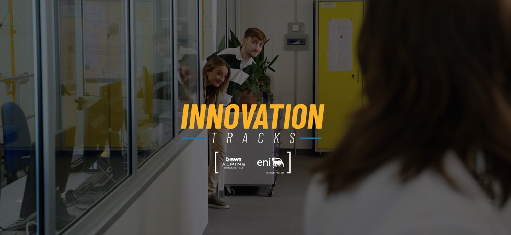 Three people peek out from a lab doorway while another stands in the foreground; overlaid text reads ‘Innovation Tracks.