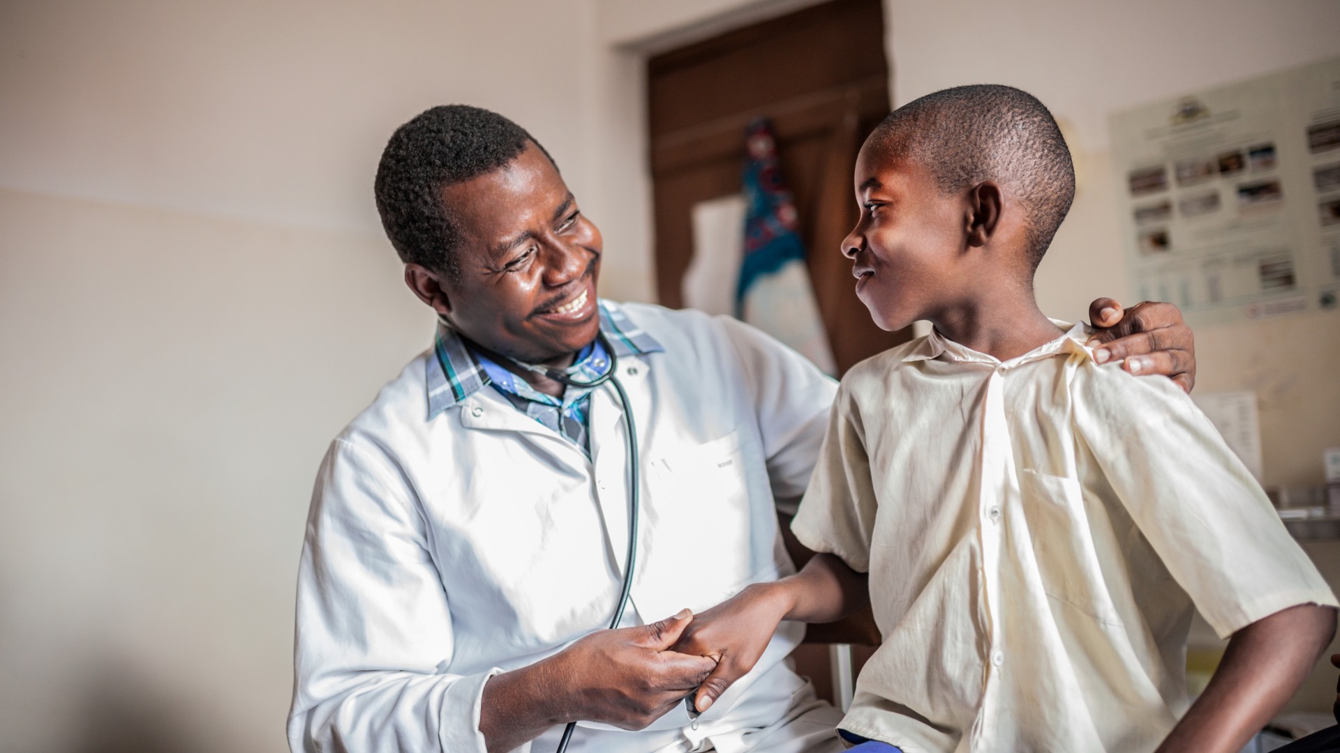 African male doctor examining child