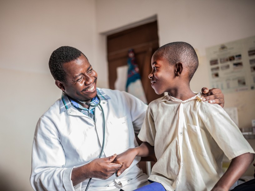 African male doctor examining child