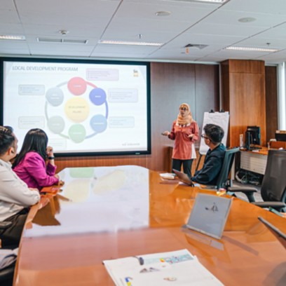 Eni employees during the meeting sitting around the table