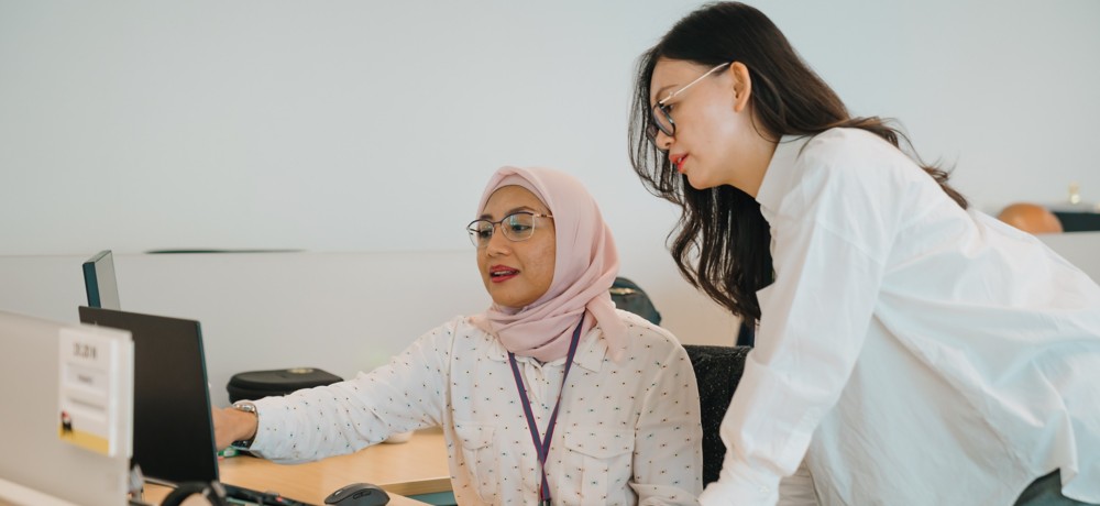 Two female colleagues confront each other in the office