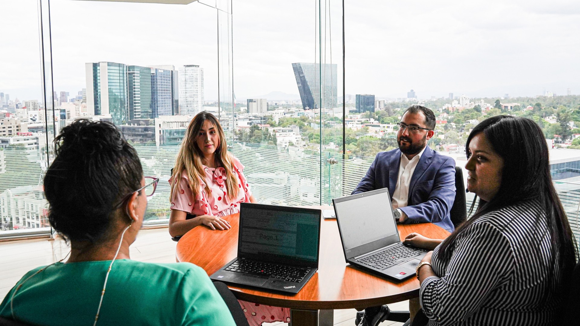 Several people sitting around a table in the office