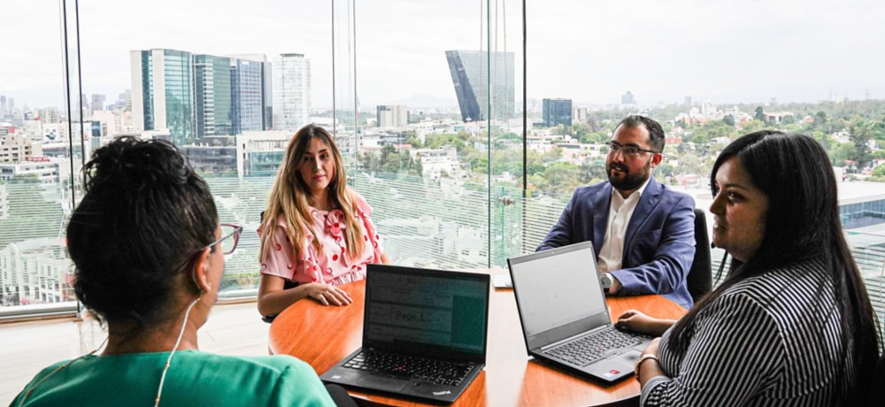 Several people sitting around a table in the office