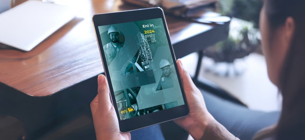 Hand holding iPad with local report Eni Mexico