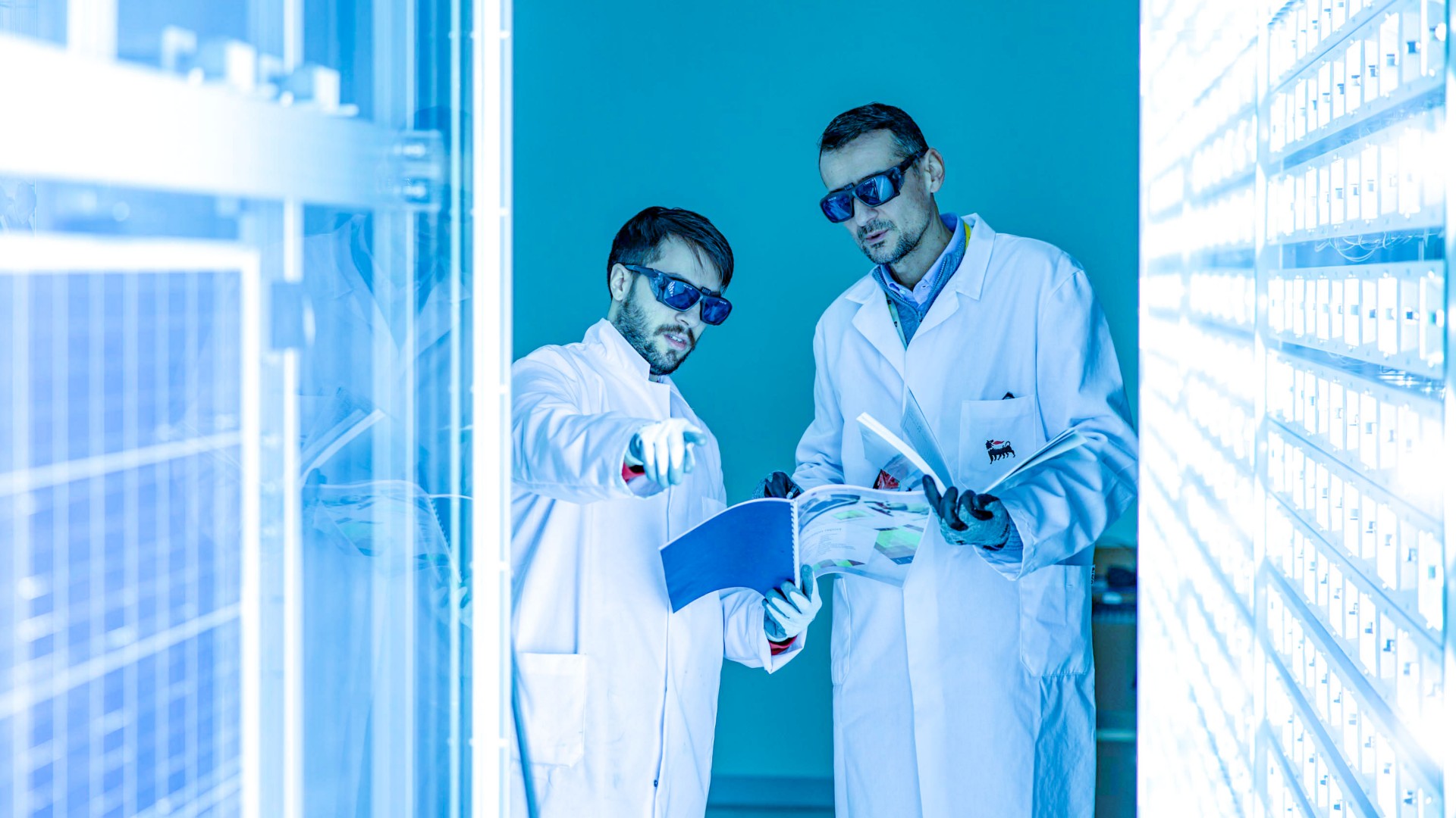 Two scientists inside the lab as they analyze the panels around them