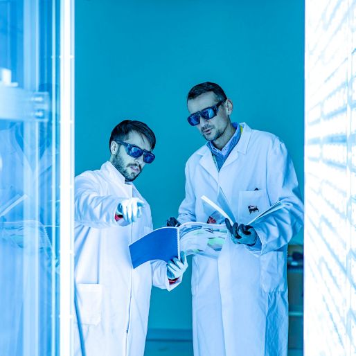 Two scientists inside the lab as they analyze the panels around them