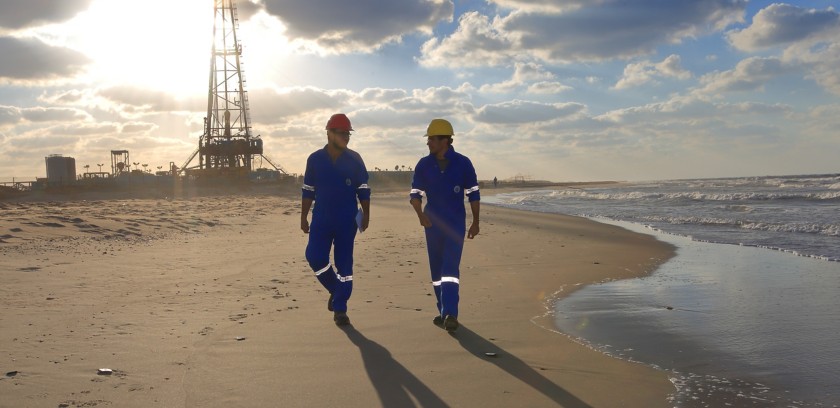 Men on the beach walk near the facility