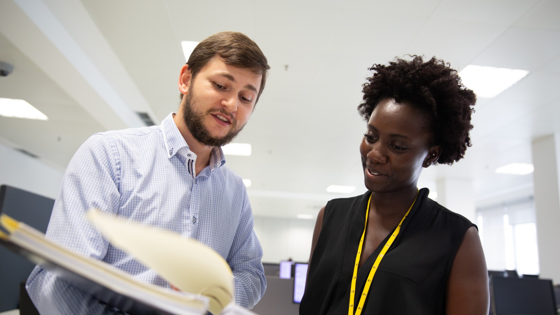 A man and a woman talking in the office