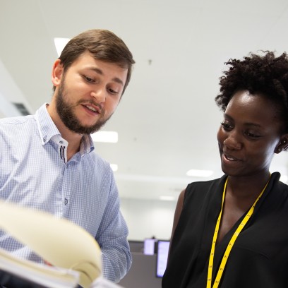 A man and a woman talking in the office