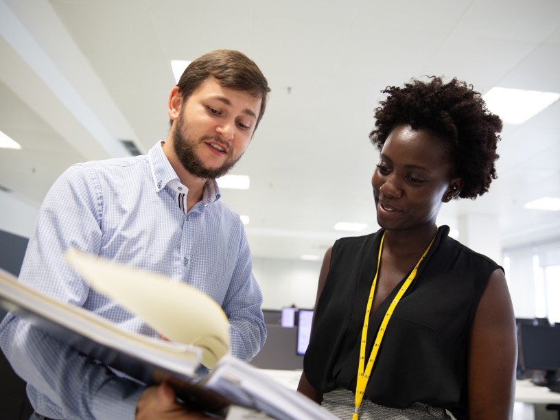 A man and a woman talking in the office