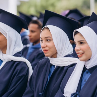 Three female students sitting together during the graduation ceremony