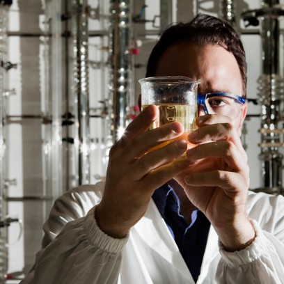 Scientist looks at test tube