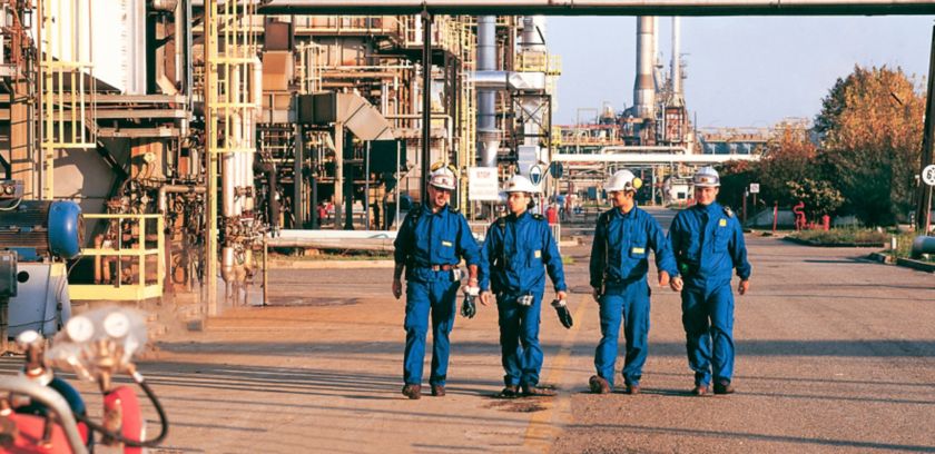 Workers walk inside the Sannazzaro refinery
