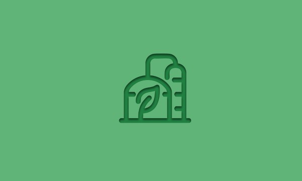 Stylized icon of an industrial plant with two cylindrical structures, one featuring a leaf in the center, set against a green background. Represents the concept of biomethane production or renewable energy.