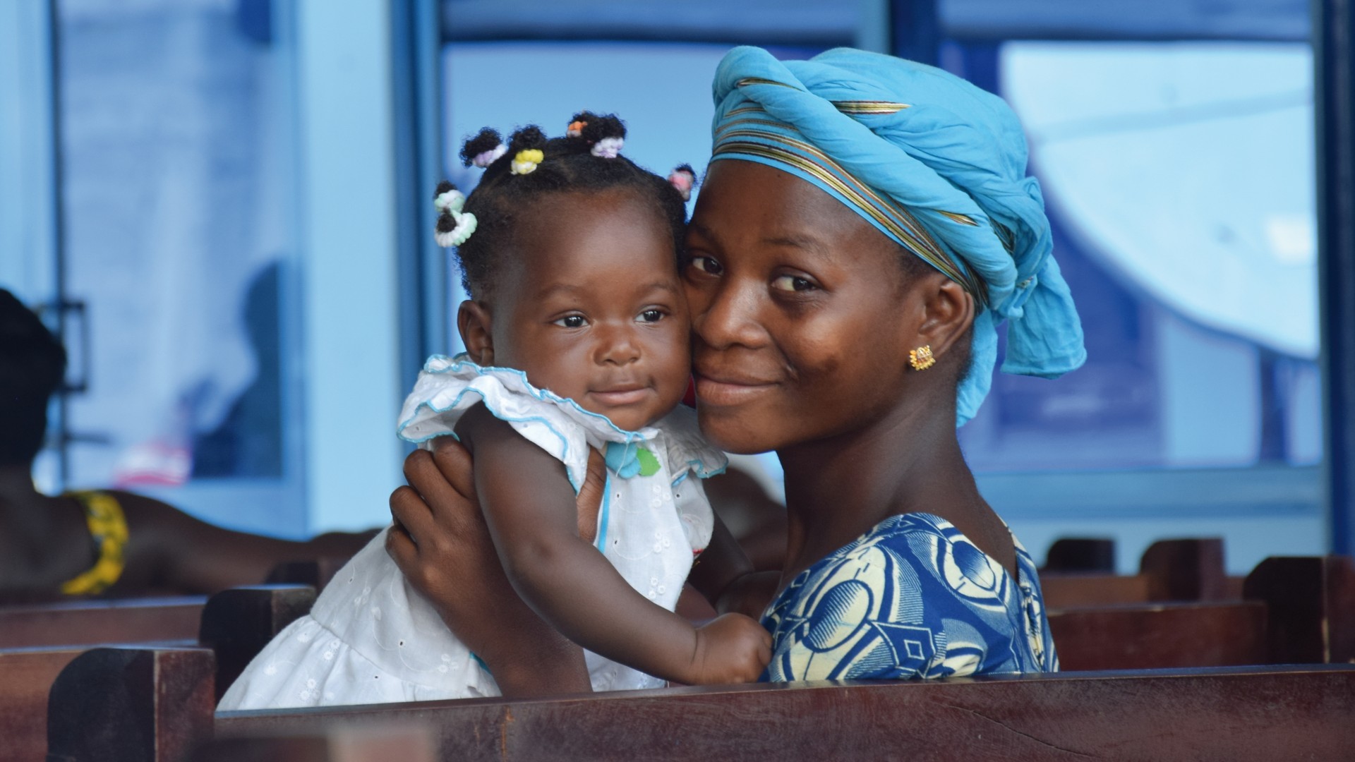 African woman embracing her baby girl