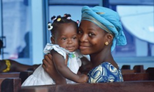 African woman embracing her baby girl