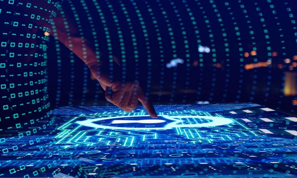 Hand touching an interactive screen with graphics