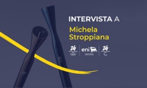 Grafica promozionale con torce stilizzate e testo "Intervista a Michela Stroppiana", loghi Milano Cortina 2026, Eni e simboli olimpici.